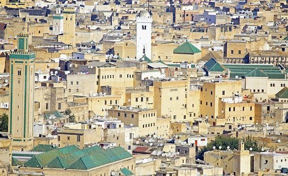 imperial-cities-fes-view-of-kairaouine-mosque-over-rooftops-slideshow-w642h350-570x350